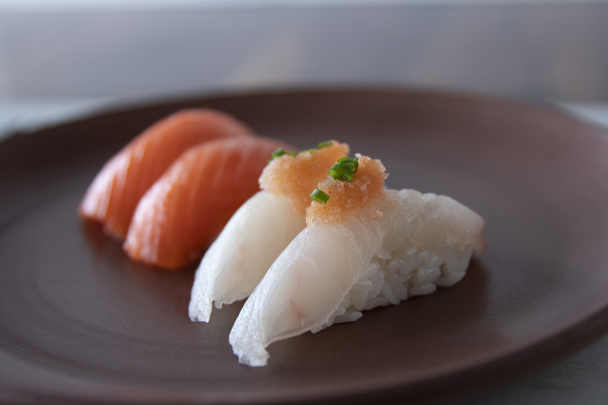 Nigiri sushi on a ceramic plate