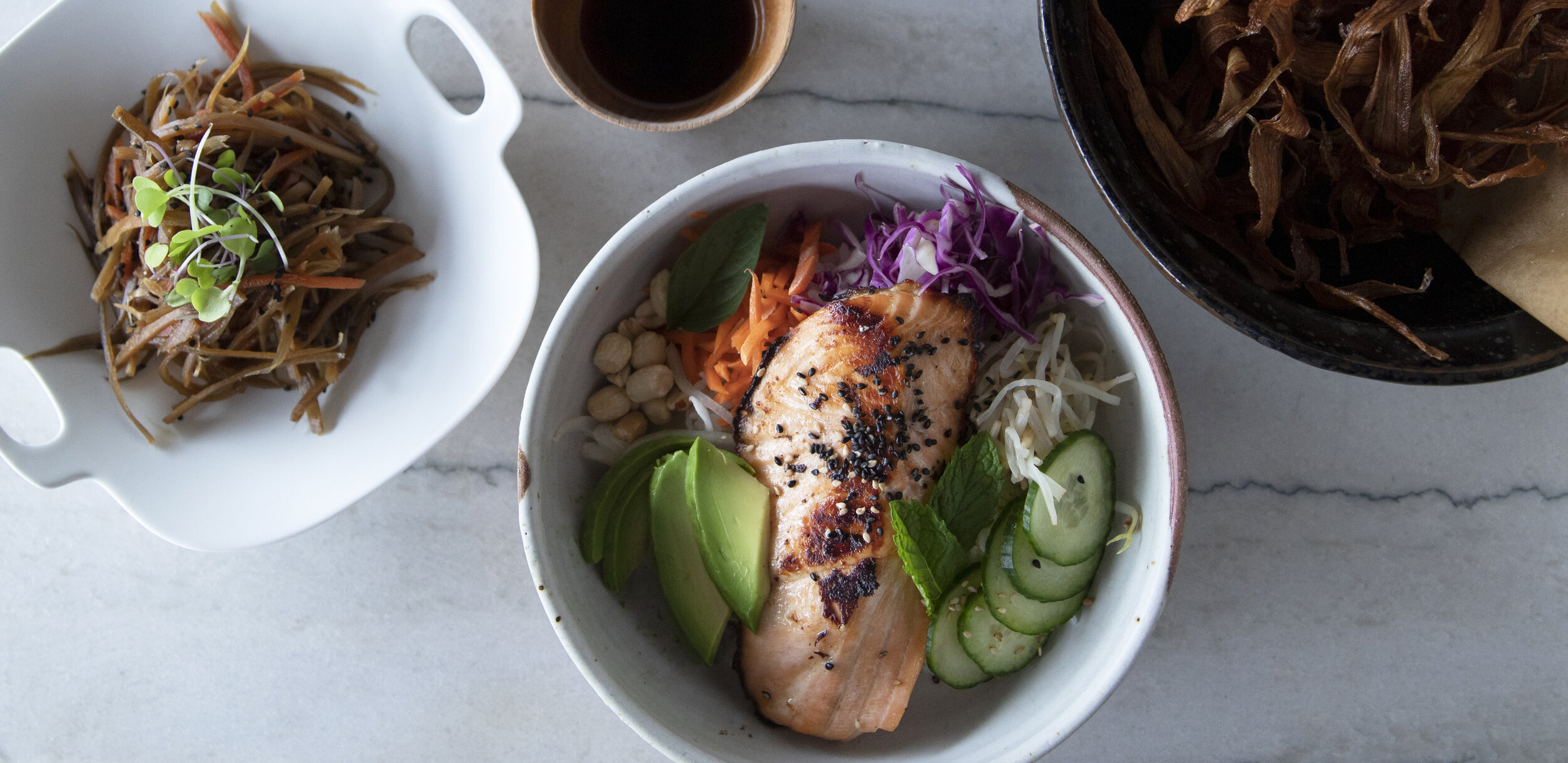 Salmon bowl with avocado, cucumber, and greens at Nuka Maui